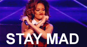 Rihanna dancing on stage with arms crossed, text: STAY MAD
